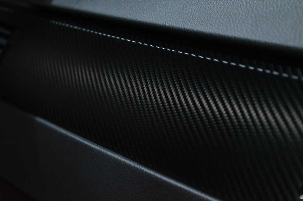 Stunning Epoxy Resins for Effortless Carbon Fiber Laminating Detailed view of a carbon fiber texture on a car interior showcasing modern design.