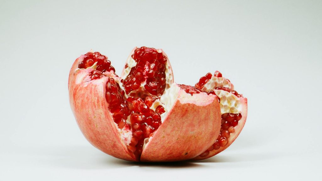 Carbon Fiber Repair: Effortless Patch Techniques for Best Results A detailed image of a sliced pomegranate with red seeds on a white background.