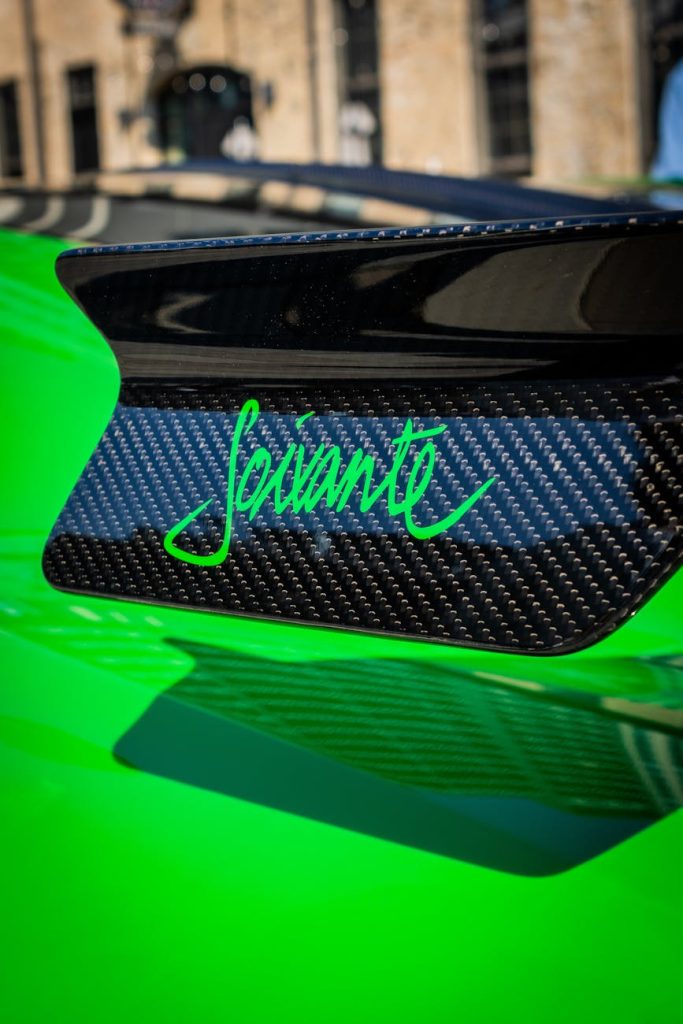 Carbon Fiber Mistakes: Avoid These Costly Pitfalls Now Close-up of a green sports car spoiler with carbon fiber texture.